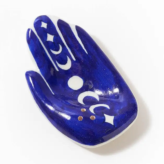 Blue decorative incense holder with white patterns on a white background