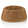 A wide woven tree collar made from natural brown raffia or straw, featuring a textured diamond-pattern weave, shown on a white surface.