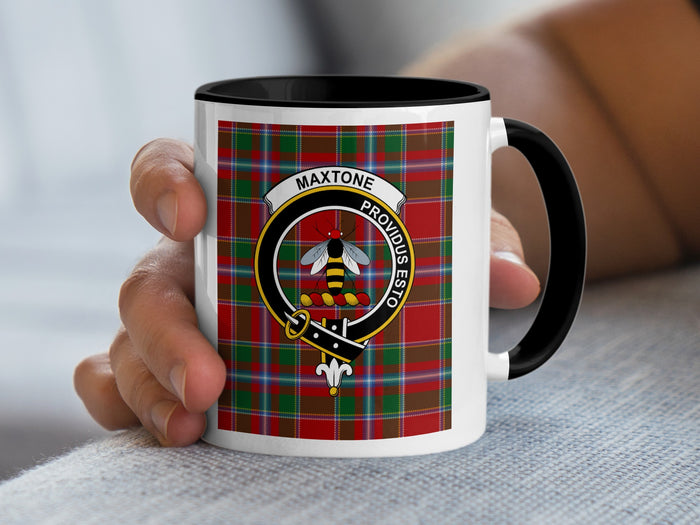 Maxtone Scottish family crest artwork on an 11 oz black accent mug with a tartan background