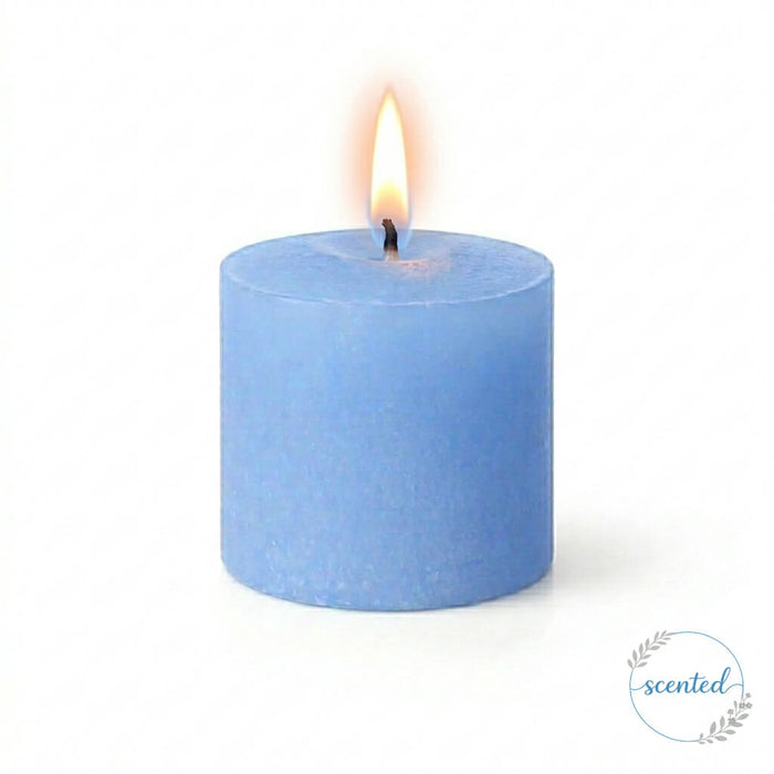 Close-up of A Lit light Blue Ocean Breeze Scented candle on a white backdrop
