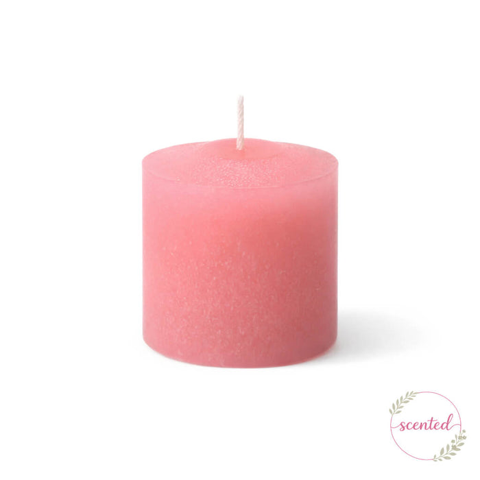 Gardenia scented pink votive candle on a white backdrop