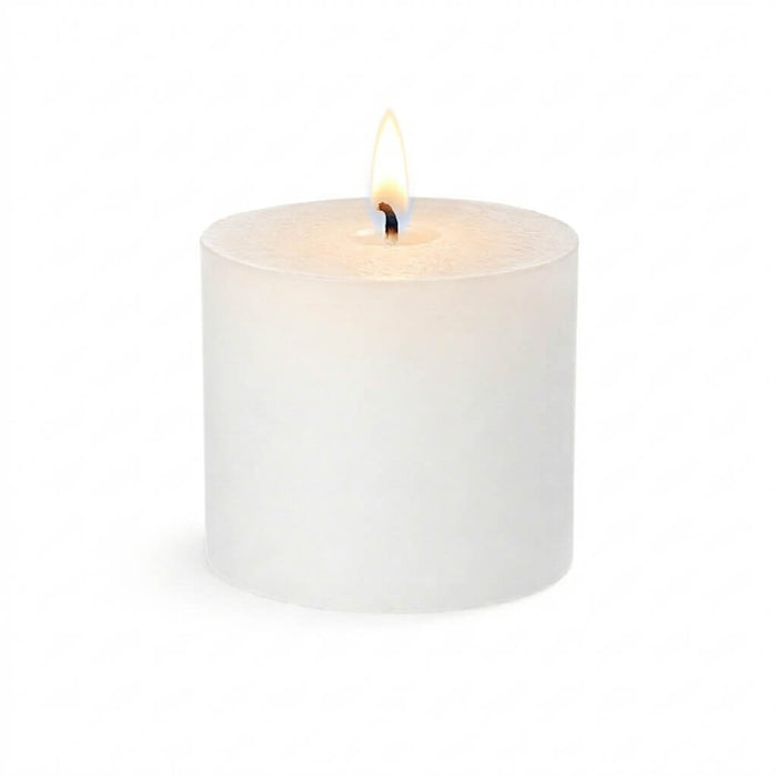 A lit white unscented votive candle isolated on a solid white background