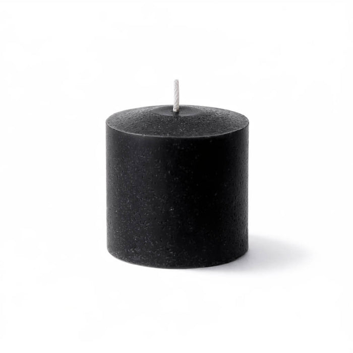 Unscented black votive candle isolated on a white background