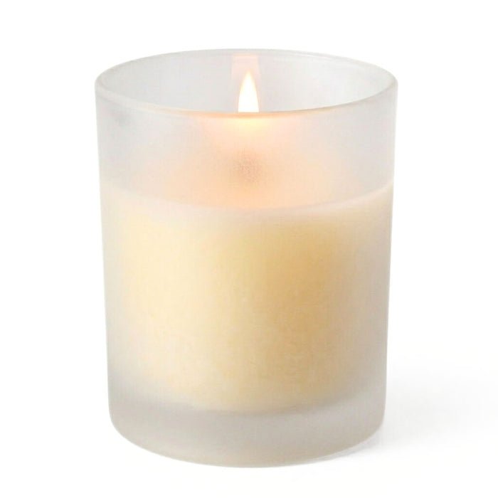 Frosted Votive Holder with a single burning ivory candle against white