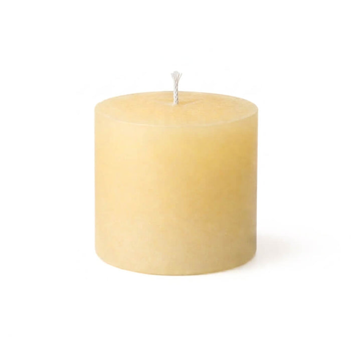 Small textured ivory candle with a single central wick against white