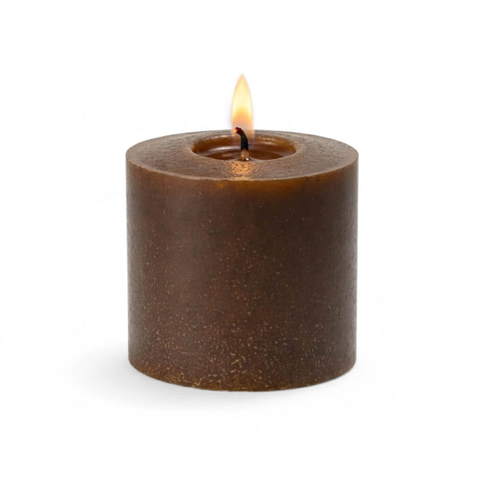 Burning unscented brown votive candle