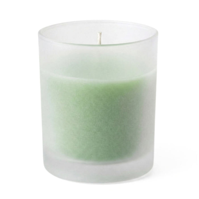 Green unscented candle in frosted glass votive holder