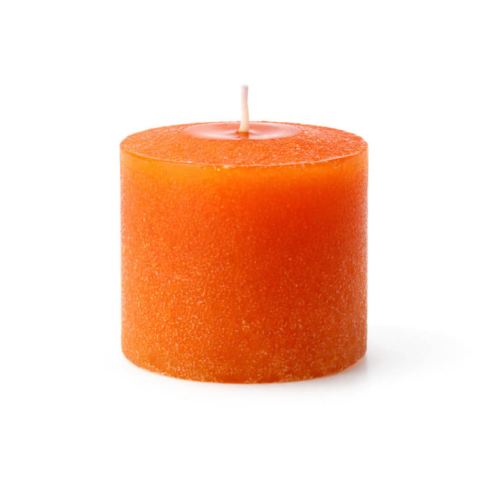 Single orange votive candle with a citrus scent