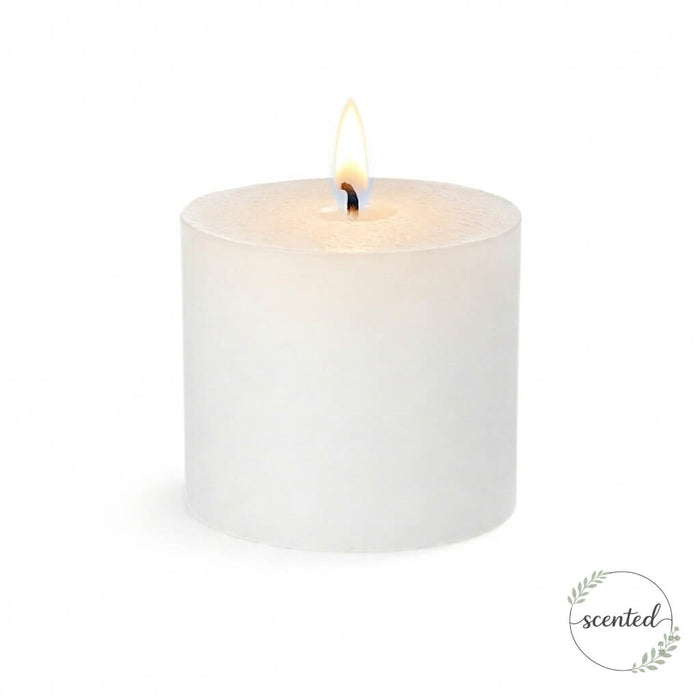 A single lit white citronella scented pillar candle