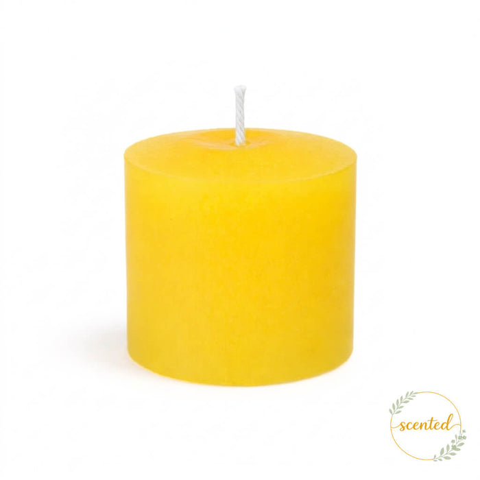 An unlit Yellow - Lemon Meringue Scented candle on a white background with a scented logo sticker