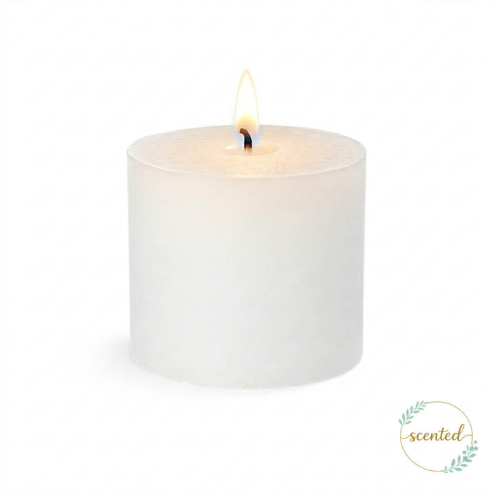 White citronella scented pillar candle with lit flame on white background