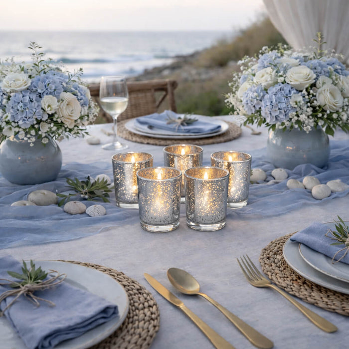 Five burning Metallic Silver Mercury Votive Holder pieces setup on an oceanfront dinner table