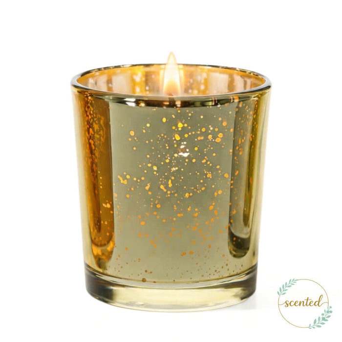 Gold mercury glass votive candle holder with glowing flame on white background