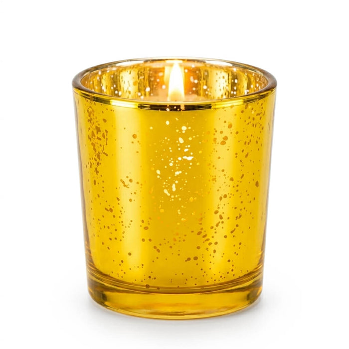 A single, lit Gold Mercury Votive Holders cup casting a warm glow against a white background