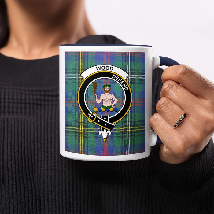 Close-up lifestyle view of Wood Scottish family crest artwork on a navy 11 oz accent mug with a tartan background